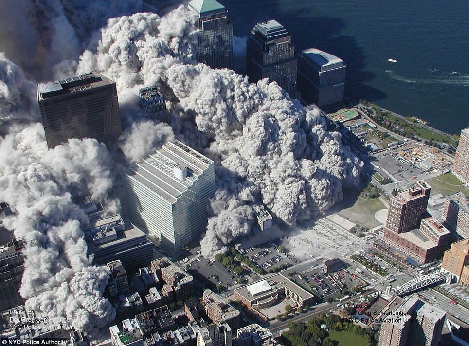 Terror: A tidal wave of dust and debris roars through lower Manhattan as the World Trade Centre coll