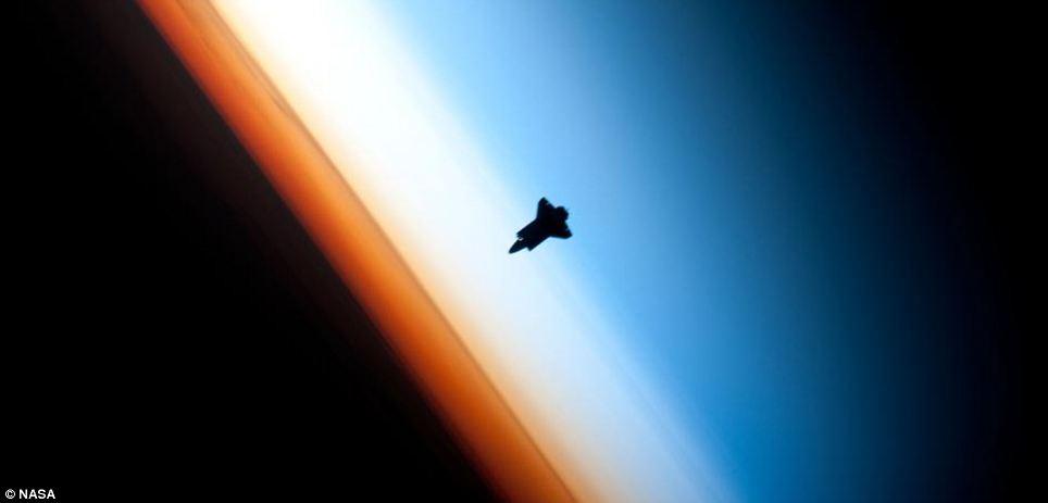 Shadow of the Earth: The silhouette of the space shuttle Endeavour above our planet